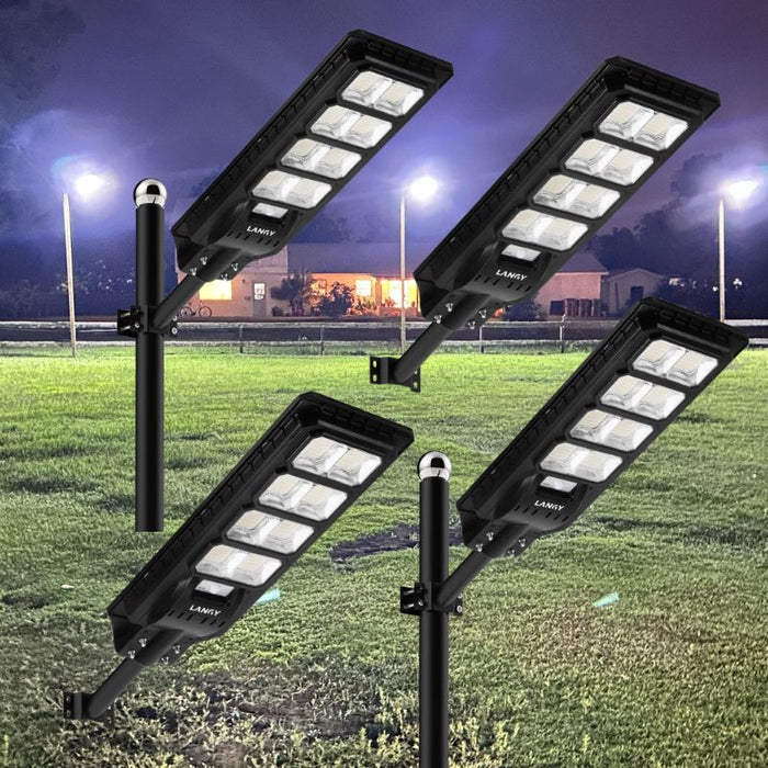 How does a tapered pole structure improve the overall wind resistance stability of solar street lights?